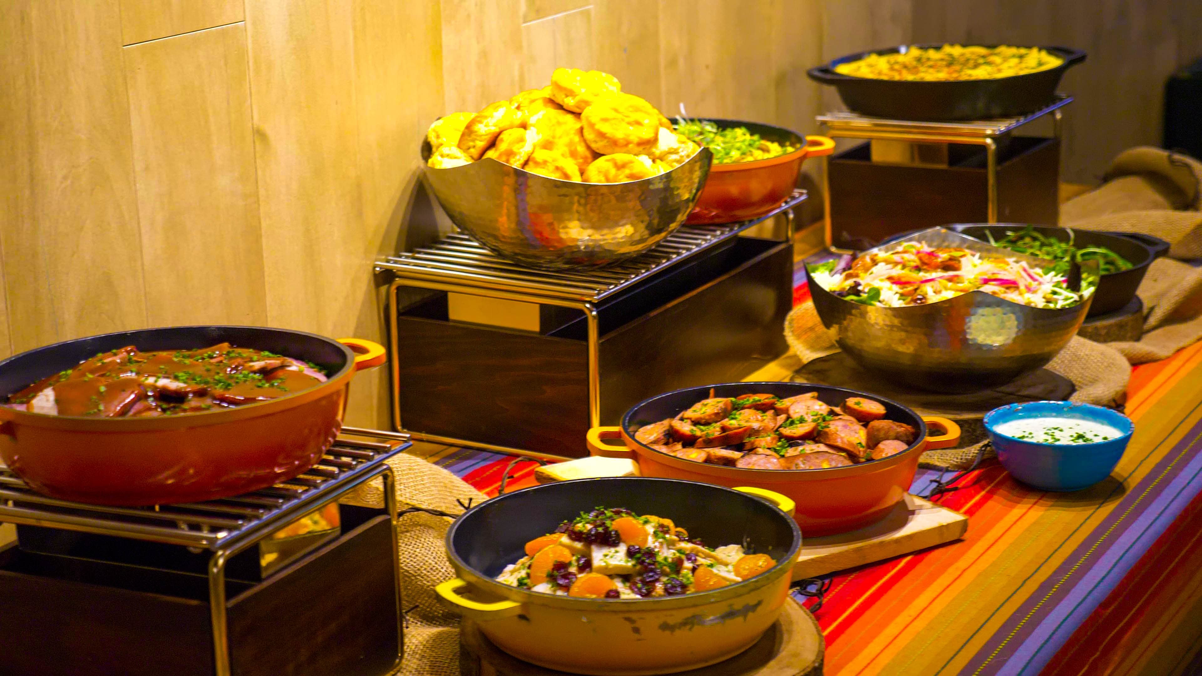 Cast-iron pots and platters set out on a long table