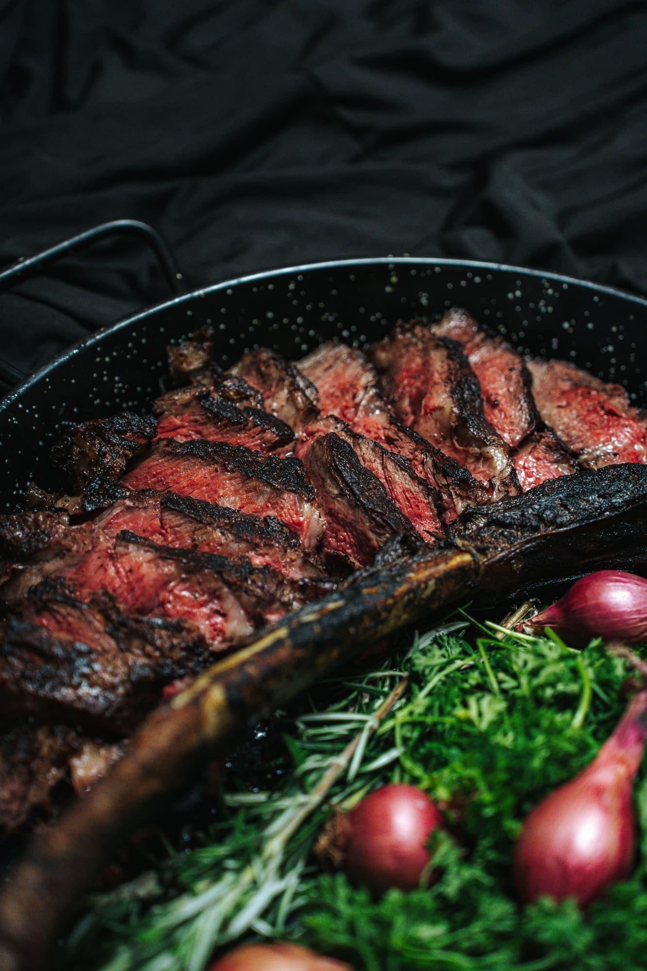 A sliced tomahawk steak plated for the table